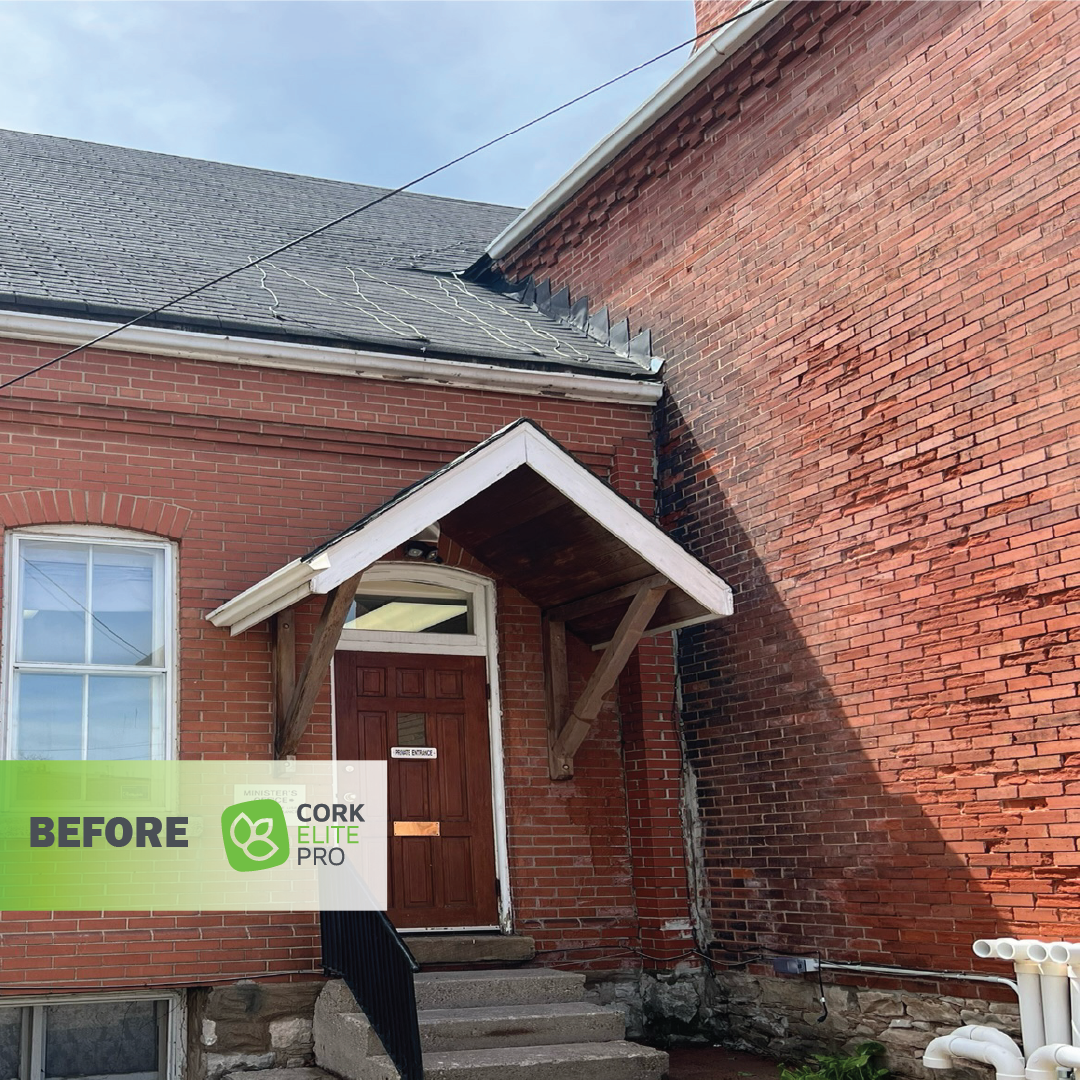 A crumbling brick house with wooden door before application of Cork Elite Pro cork spray.