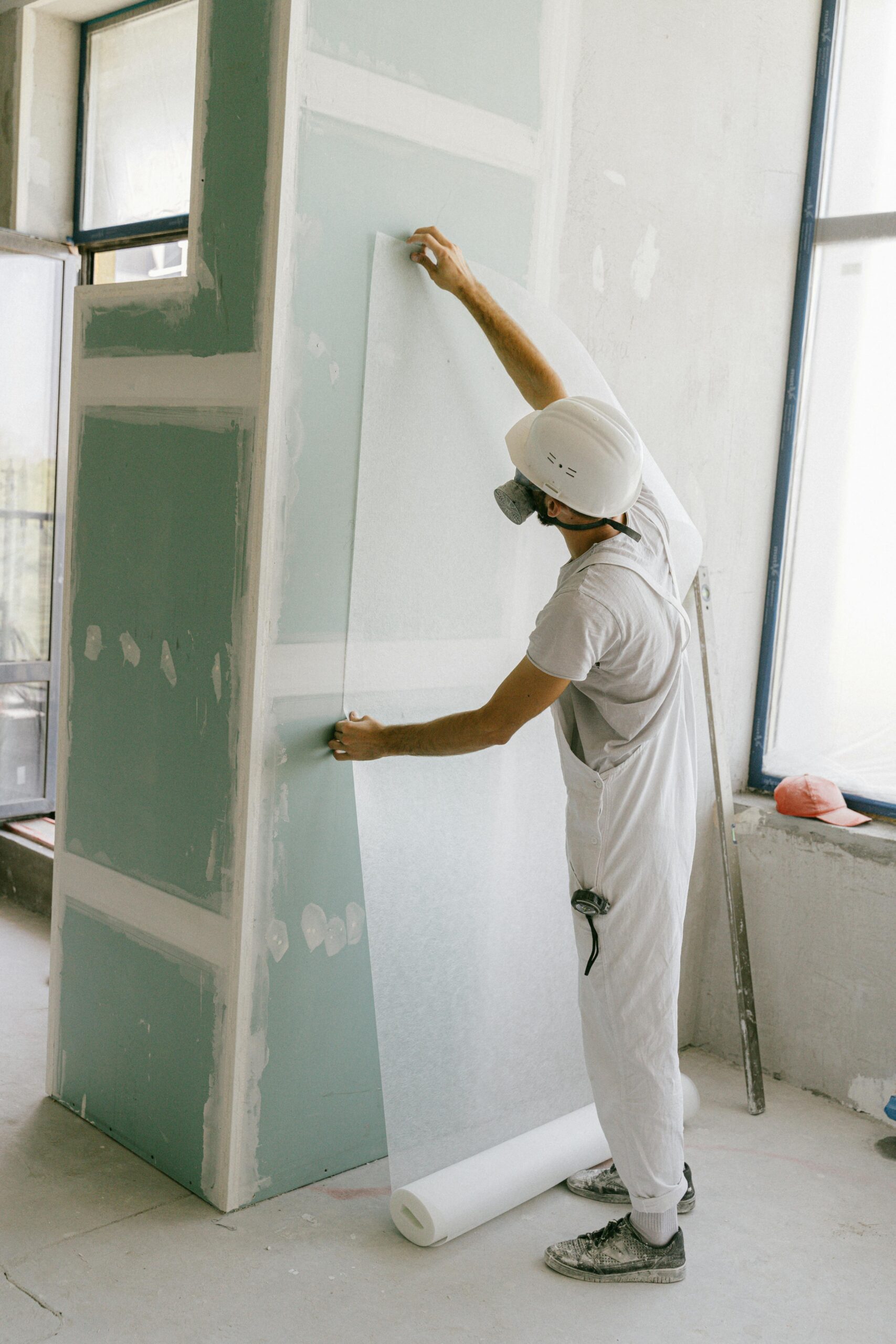 A contractor installs drywall/cement board.